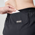 woman wearing brooks cascadia running short, lightweight women's trail-running shorts, black with white logo, close up of back pocket of short
