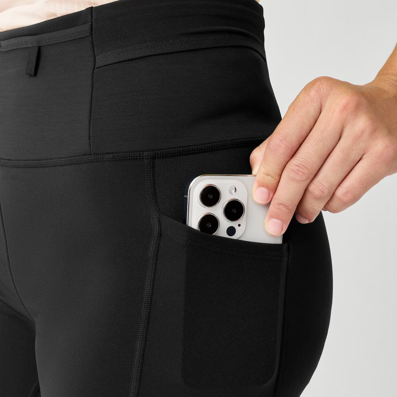 brooks cascadia short tight, 6" fitted running shorts for women, black colour, close up of phone storage pocket in brooks short on a white background