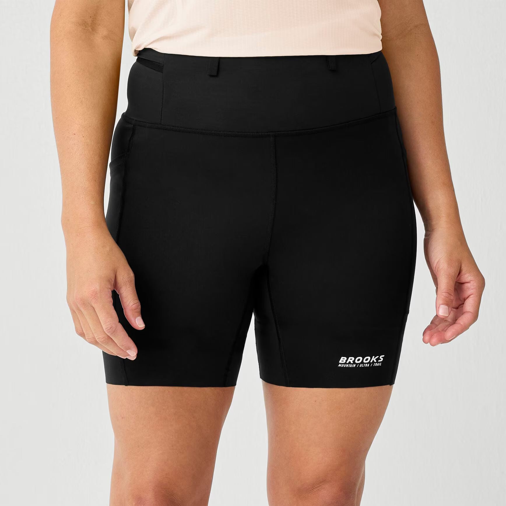 brooks cascadia short tight, 6" fitted running shorts for women, black colour, profile of woman wearing brooks short on a white background