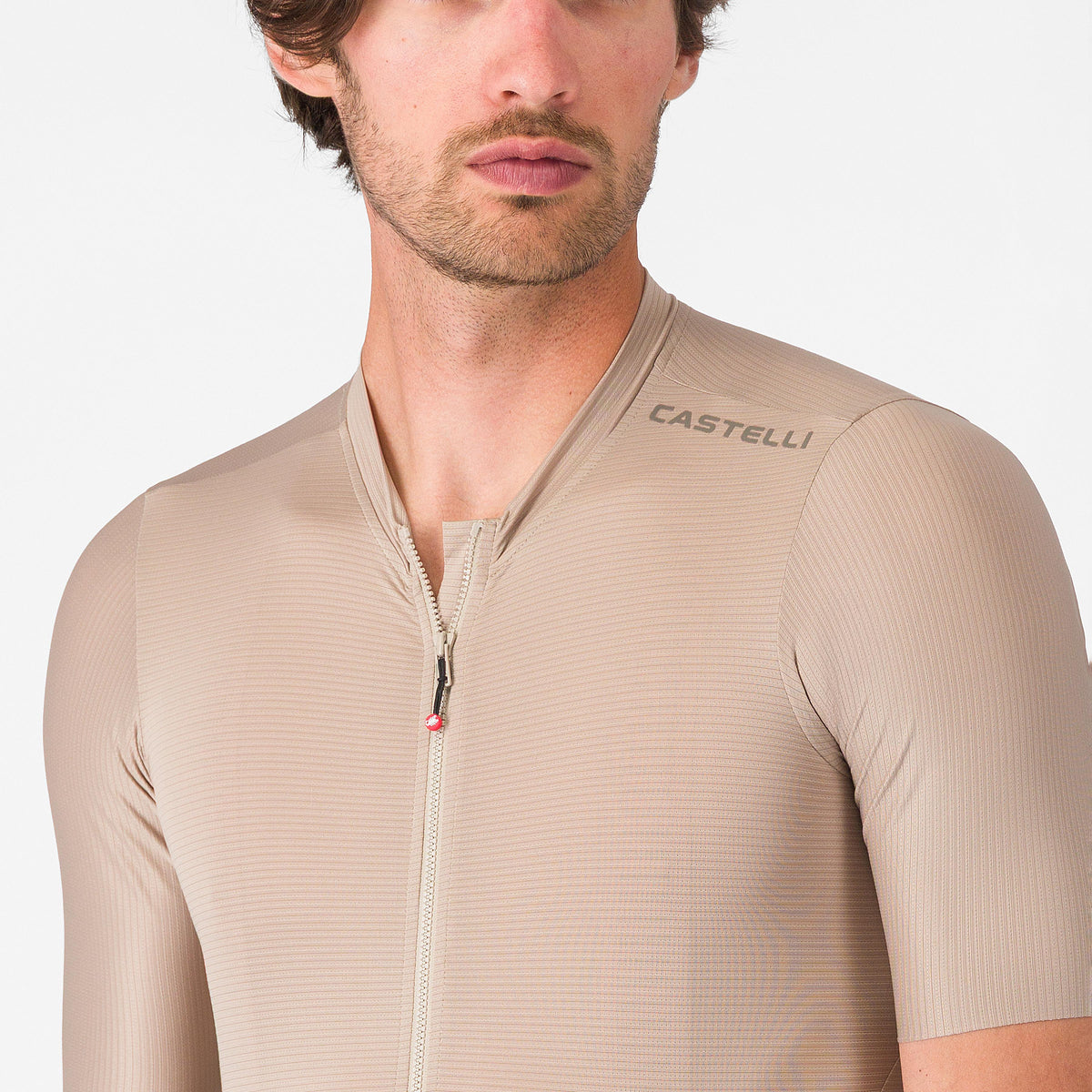 close up of shoulder of castelli espresso 2 jersey, showing logo, clay colour