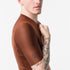 close up of shoulder of castelli espresso 2 jersey, showing scorpion logo, mocha colour