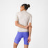 Woman wearing the castelli espresso DT 2 bibshort in purple colour, showing back