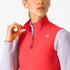 Woman wearing a Castelli Espresso Vest in hibiscus red, showing zip and collar