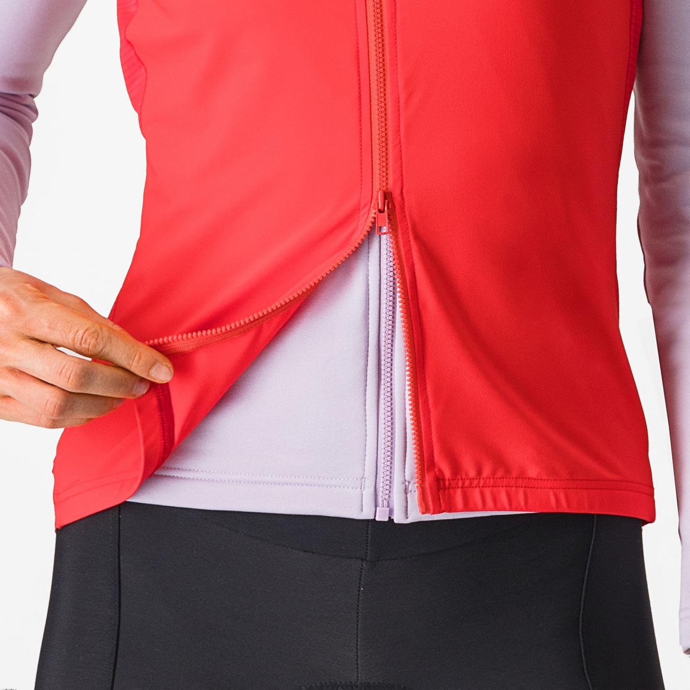 Woman wearing a Castelli Espresso Vest in hibiscus red, showing zip