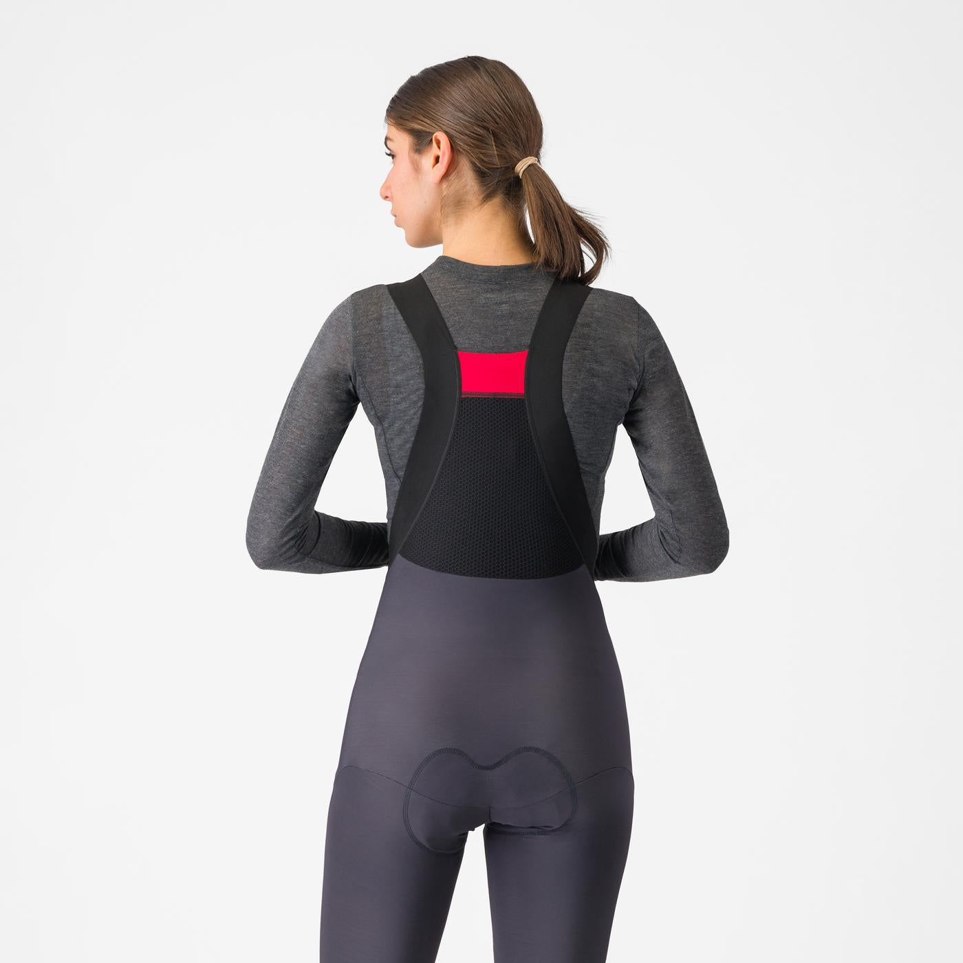 woman wearing castelli medio base layer with castelli bibtights