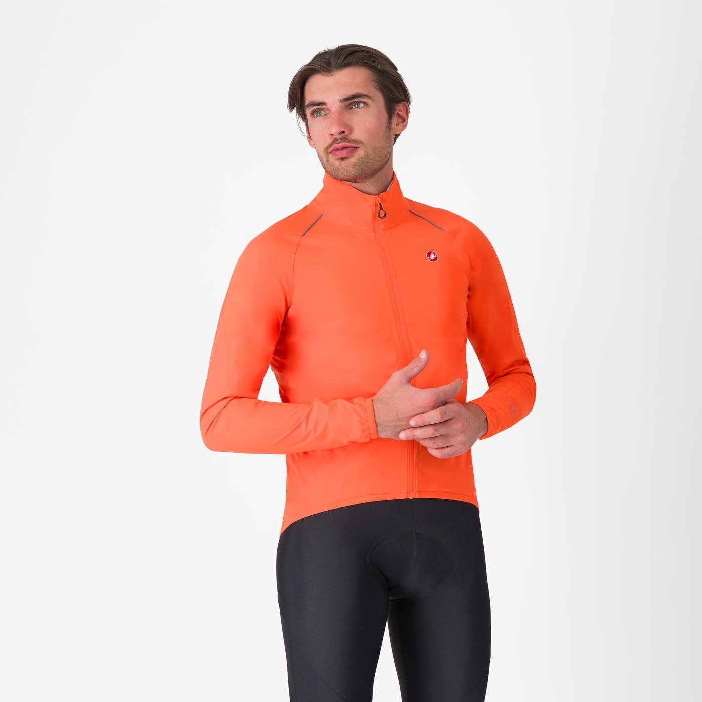 Man wearing an orange castelli emergency 3 rain jacket for cycling