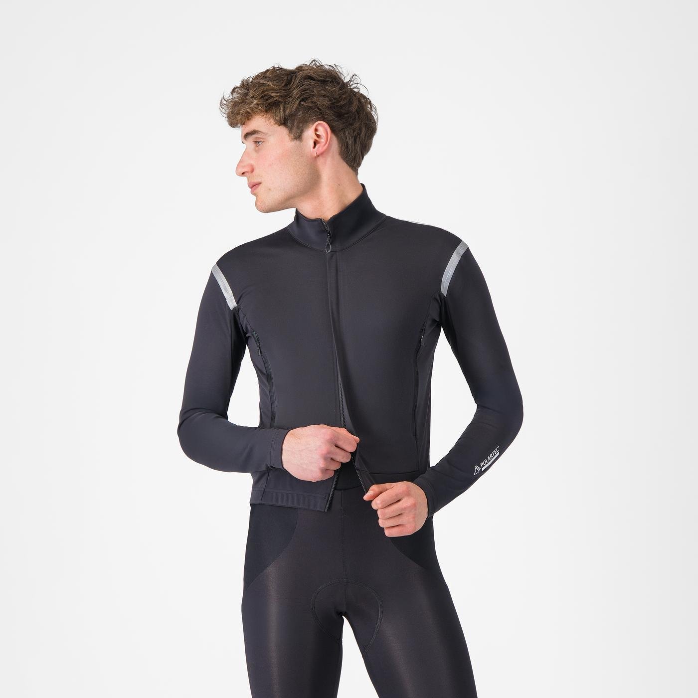 castelli perfetto ros 3 jacket, water resistant windproof breathable cycling jacket, black colour with reflective grey details, man wearing castelli jacket unzipping from bottom