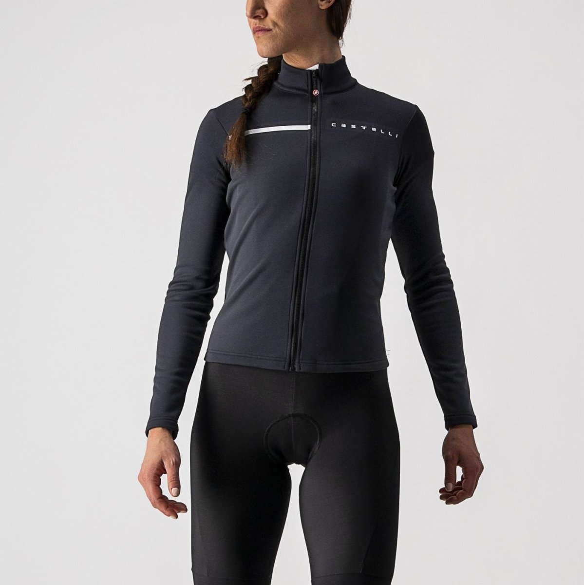 woman wearing light black castelli sinergia thermal cycling jacket, showing reflection and logo at front