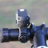 Close-up of a Cateye bike light attached to bicycle handlebars. ampp 900