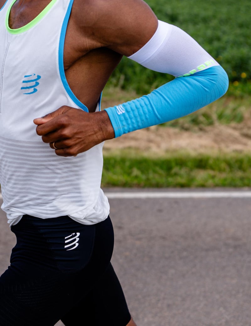 man running in compressport armforce armsleeves in blue and white