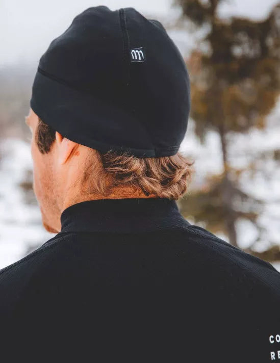 compressport hurricane beanie, warm moisture wicking hat, black colour, person wearing compressport hat outside