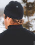 compressport hurricane beanie, warm moisture wicking hat, black colour, person wearing compressport hat outside