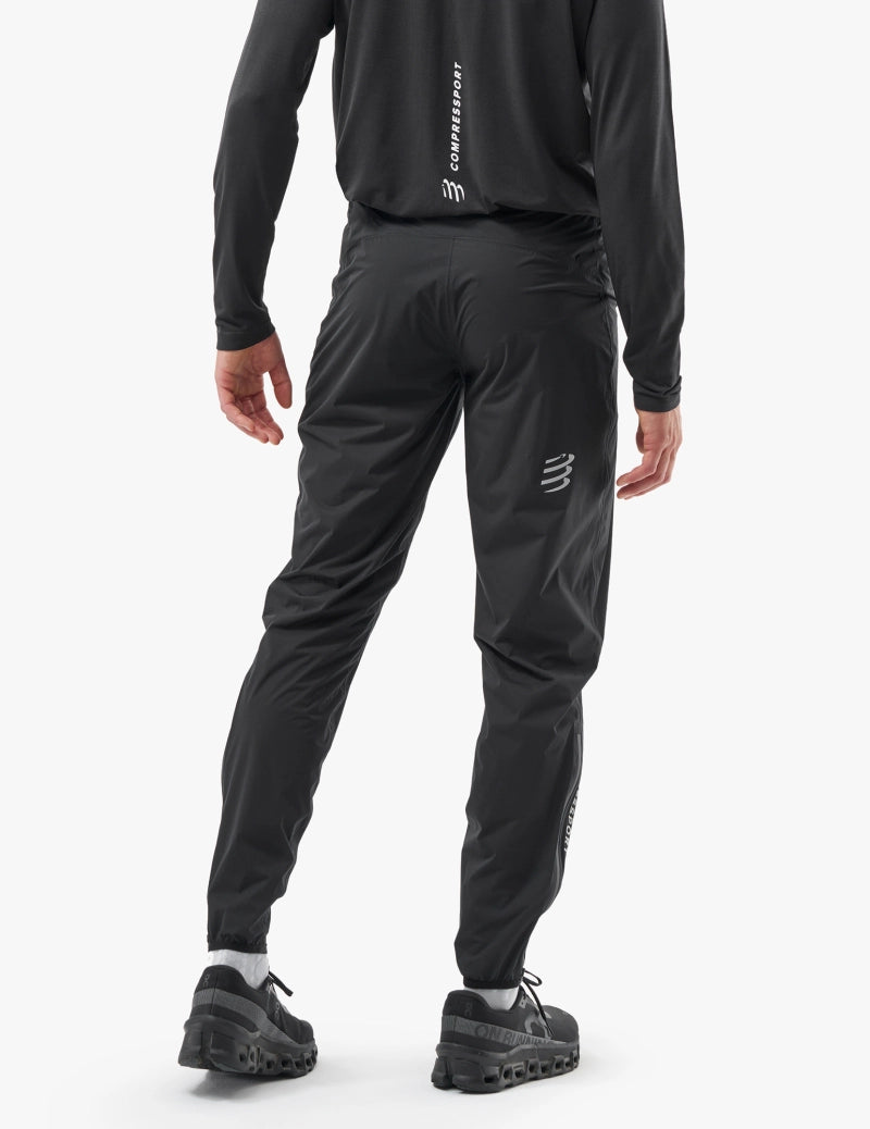 compressport hurricane pants 2.0, lightweight super breathable waterproof running pant, black colour, male model back view