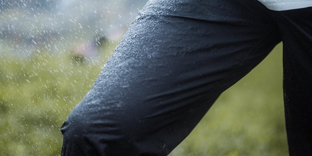 compressport hurricane pants 2.0, lightweight super breathable waterproof running pant, black colour, up close of waterproof material