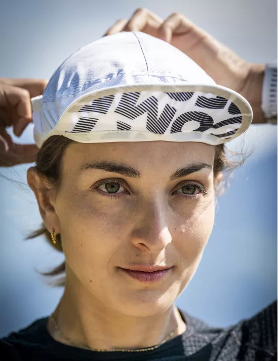 compressport ice cap sun shape, woman wearing white running hat tucking in neck protection close up on brim