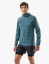 compressport tempest waterproof jacket, breathable and waterproof running jacket, deep aqua blue colour, man with jacket fully zipped