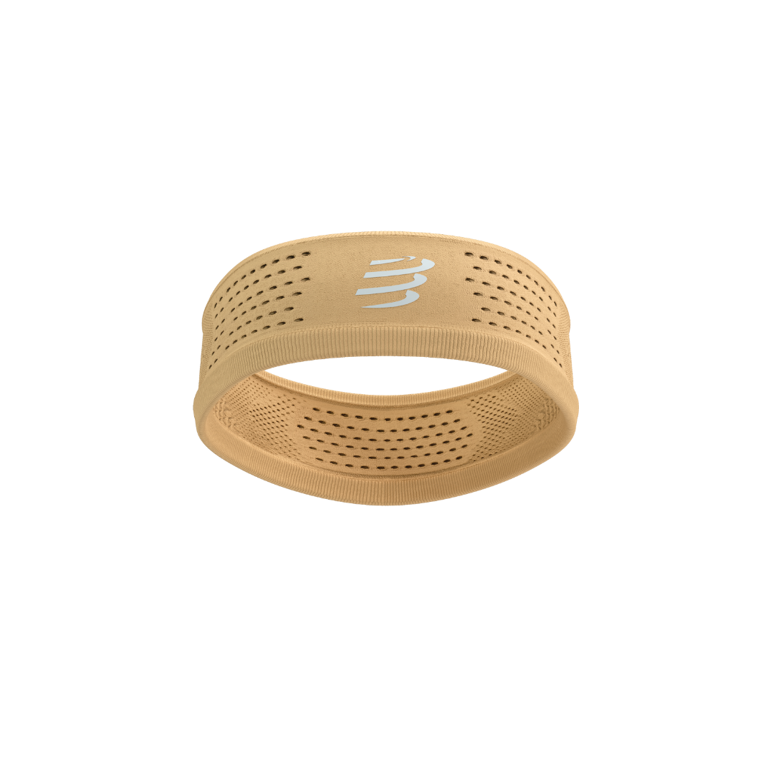 Thin sports headband from compressport, in orange buff colour