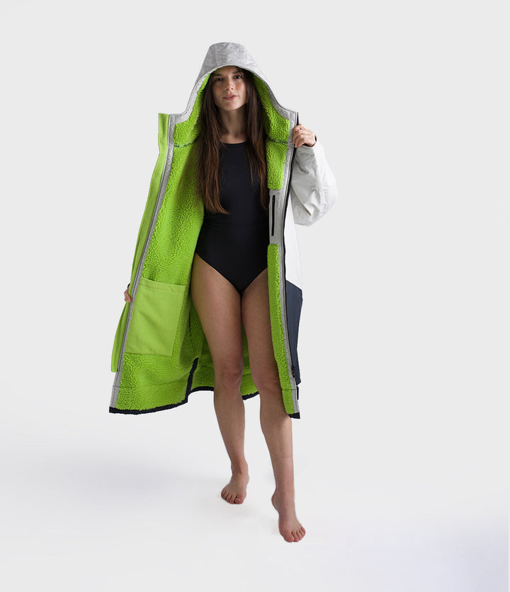 dryrobe long sleeve changing robe for all gender, light grey and navy colour with lime green interior, woman wearing dryrobe zipped down