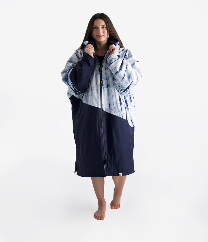 dryrobe long sleeve changing robe for all gender, light blue tie dye colour with dark blue contrast, woman wearing dryrobe zipped up