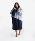 dryrobe long sleeve changing robe for all gender, light blue tie dye colour with dark blue contrast, woman wearing dryrobe zipped up