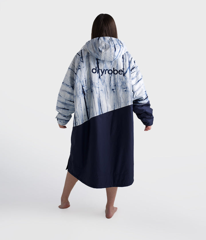dryrobe long sleeve changing robe for all gender, light blue tie dye colour with dark blue contrast, woman wearing dryrobe, back profile