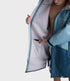 dryrobe long sleeve changing robe for all gender, light blue colour with dark blue contrast, close up of man wearing dryrobe zipped down, displaying light grey interior