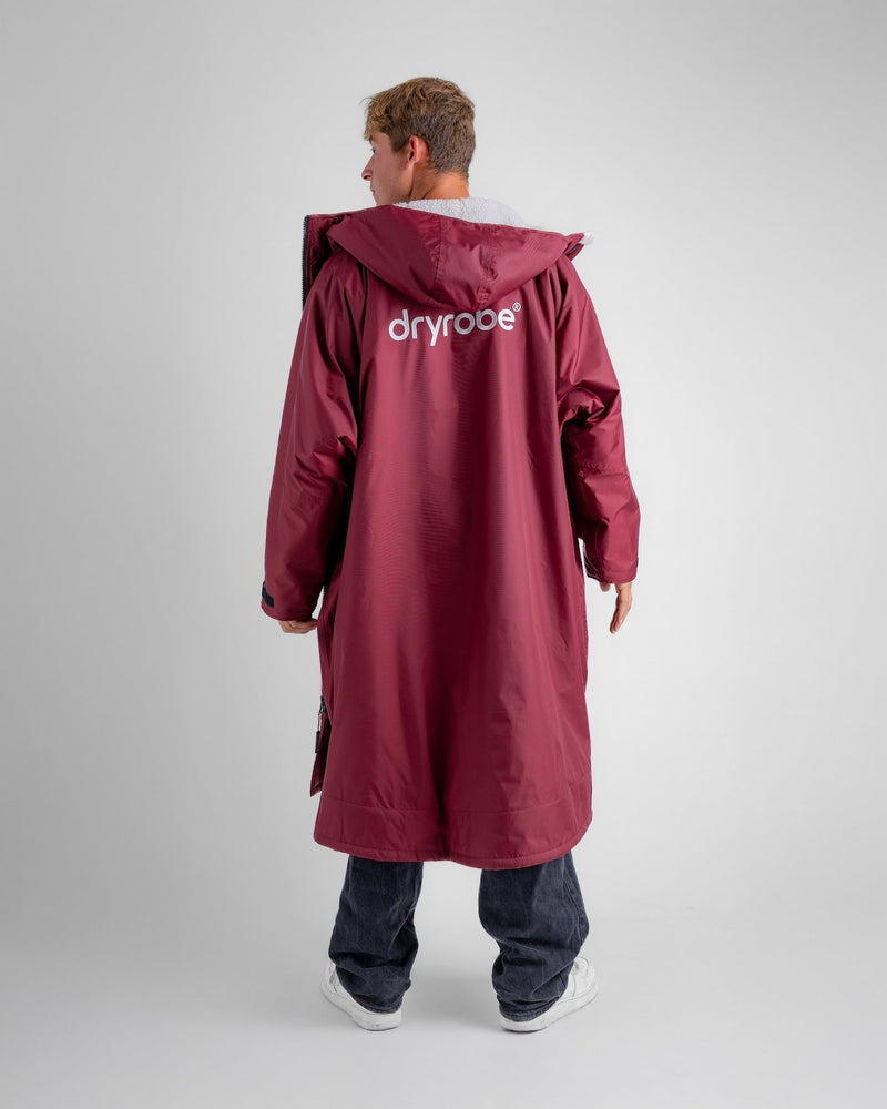man wearing dryrobe changing robe in new burgundy colour showing logo at back