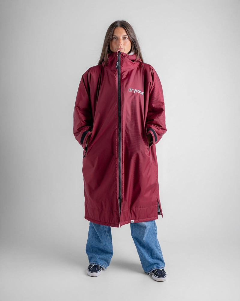 woman wearing dryrobe changing robe in new burgundy colour with zip up