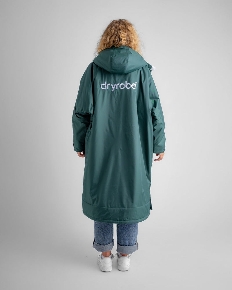 woman wearing new colour green in dryrobe long sleeve advance, showing logo on the back
