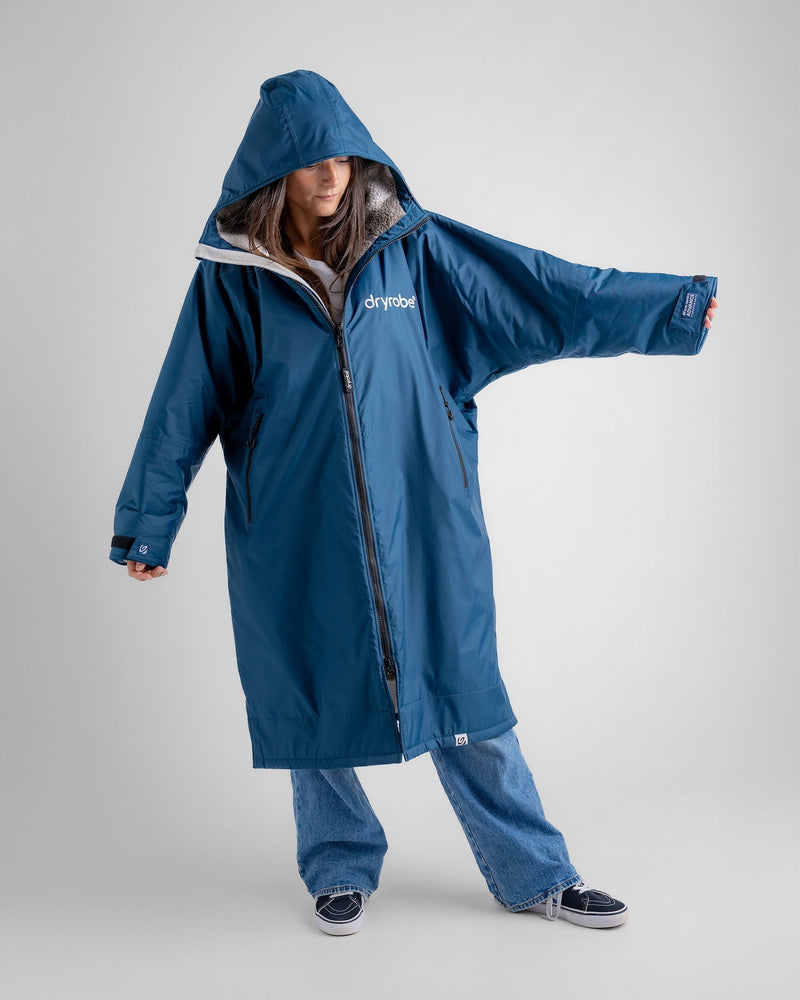 woman wearing dryrobe long sleeve changing robe showing arm length and hood up