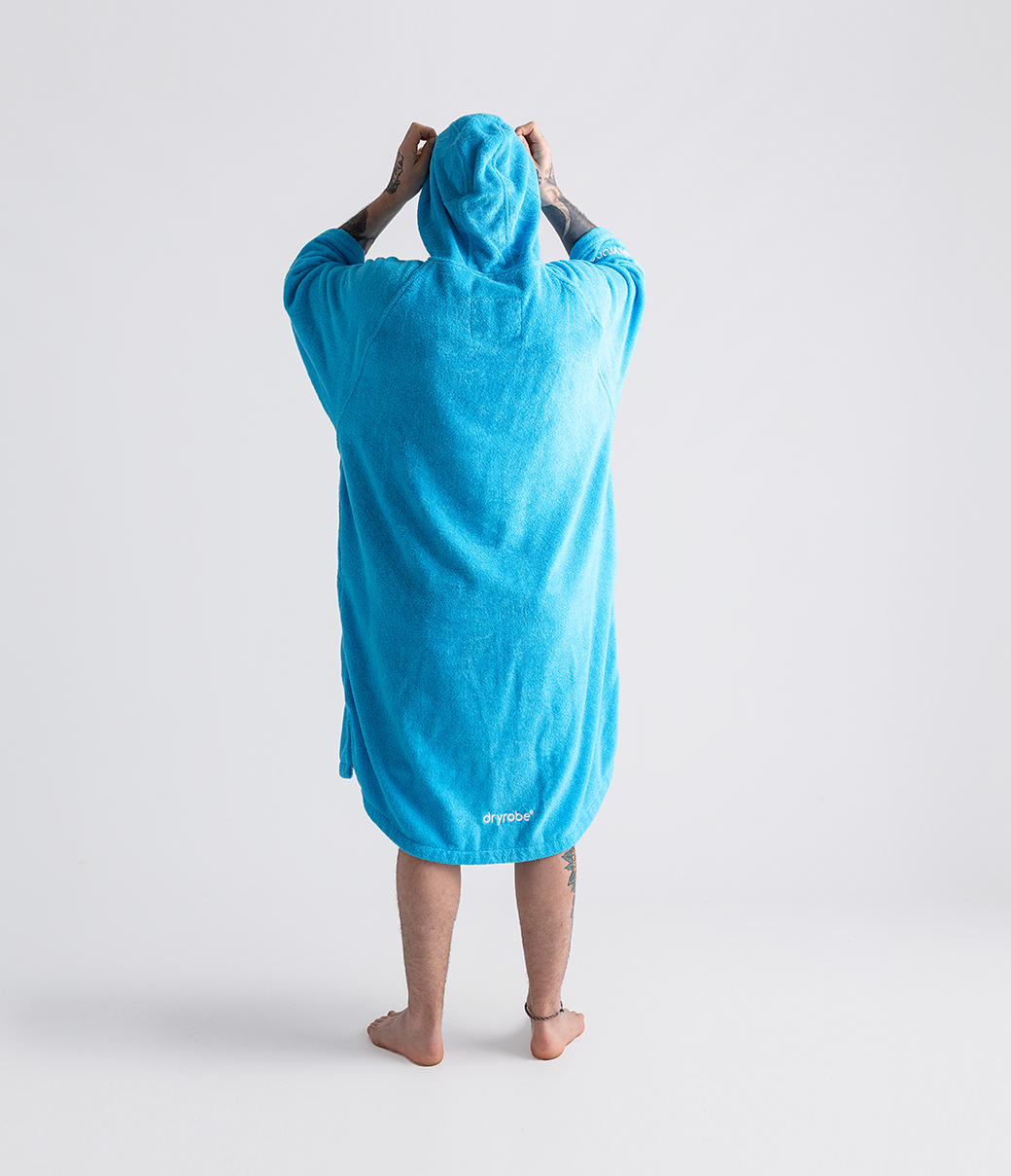 dryrobe organic cotton changing robe for swimming, soft and absorbent towelling robe for all gender, blue colour, back profile of man wearing dryrobe towel on a white background