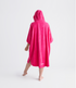 dryrobe organic cotton changing robe for swimming, soft and absorbent towelling robe for all gender, hot pink colour, back profile of woman wearing dryrobe towel on a white background