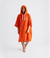dryrobe organic cotton changing robe for swimming, soft and absorbent towelling robe for all gender, orange colour, woman wearing dryrobe towel on a white background