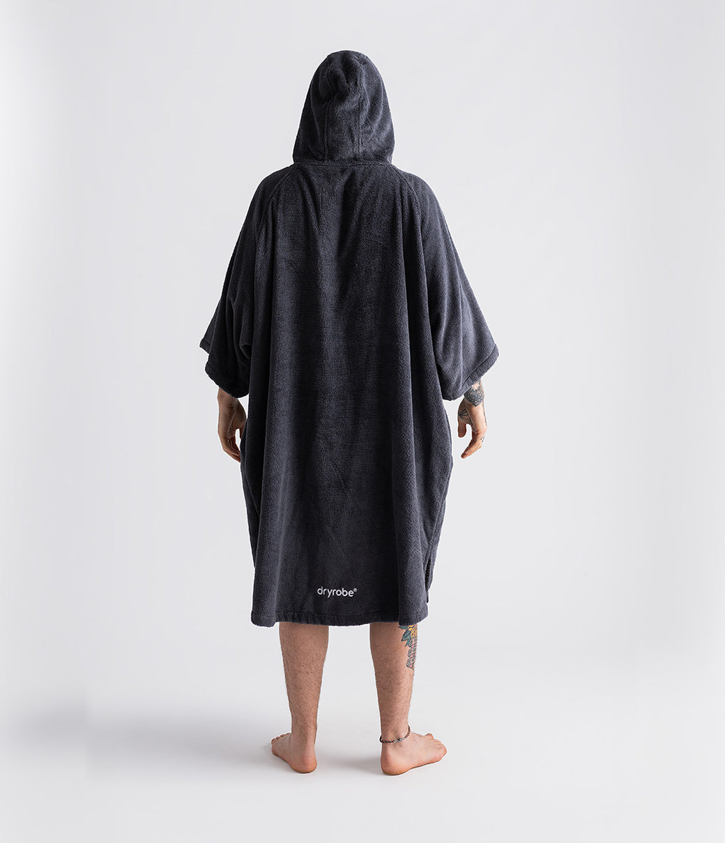 dryrobe organic cotton changing robe for swimming, soft and absorbent towelling robe for all gender, dark grey colour, man wearing dryrobe towel on a white background