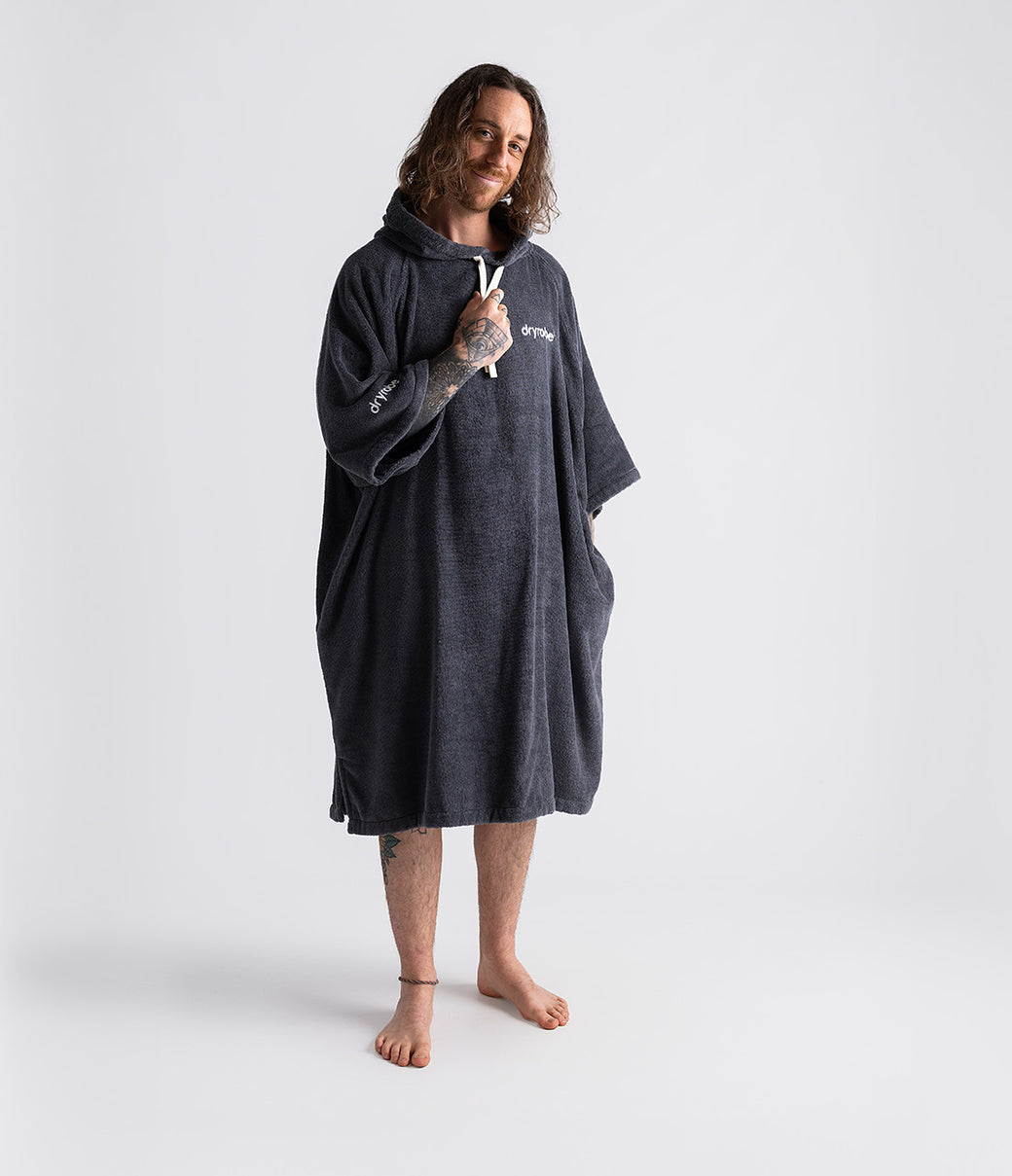 dryrobe organic cotton changing robe for swimming, soft and absorbent towelling robe for all gender, dark grey colour, man wearing dryrobe towel on a white background