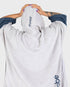 dryrobe towel robe for men and women, full zip towel robe for after swimming, light grey white colour with grey sleeve caps, dryrobe with hood up from behind