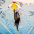 women underwater swimming in pool with snorkle and yellow finis swimming kickboard 