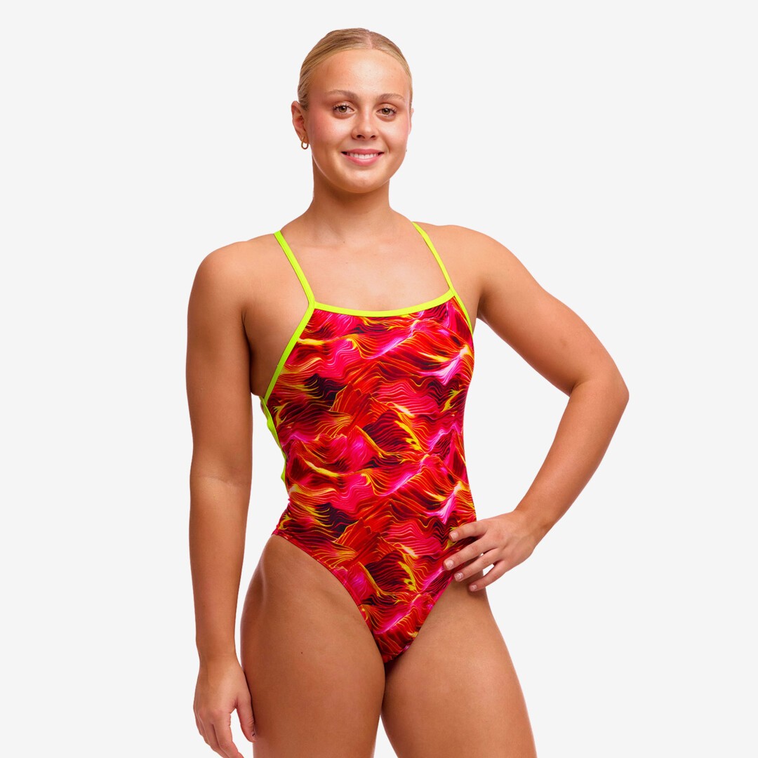 woman wearing funkita saucy sonar pattern in the strapped in swimsuit style