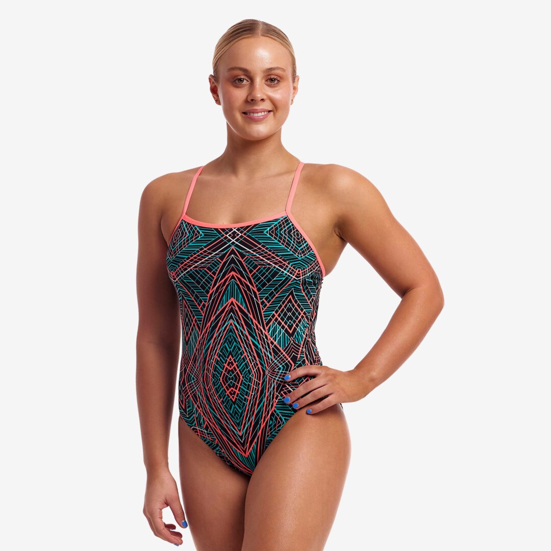 funkita swim secure, womens period proof swimsuit, pink blue and white geometric pattern on black background, woman wearing swimsuit