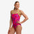 funkita womens single strap swim suit, one peice swim suit with thing strap and open back, pink with lime strap, woman wearing swimsuit on white background