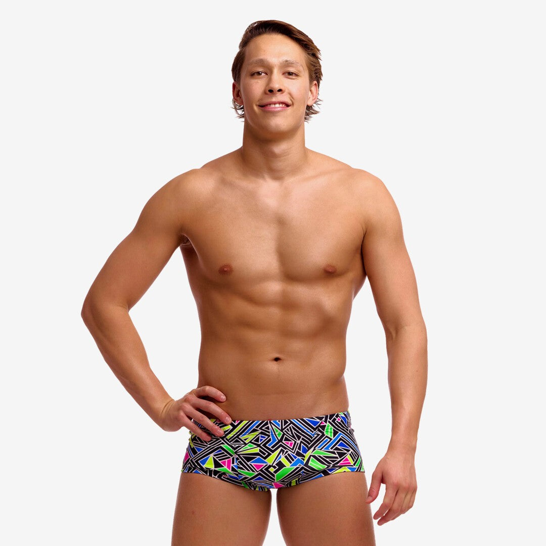 man wearing funky trunks classic trunks in bits of peace pattern
