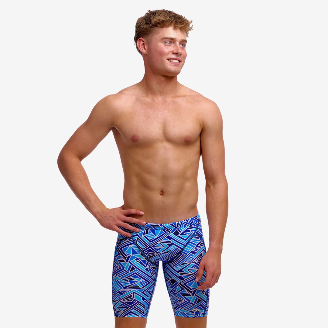 Boy wearing funky trunks jammer in blue bits pattern