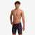 funky trunks boys jammers, boys swimming trunks, black with rainbow pattern, boy wearing swimming bottoms on white background
