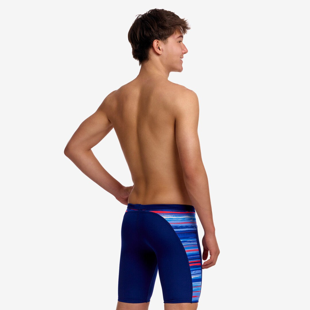 funky trunks boys jammers, boys swimming trunks, navy with blue and red side panel, back of boy wearing swimming bottoms on white background