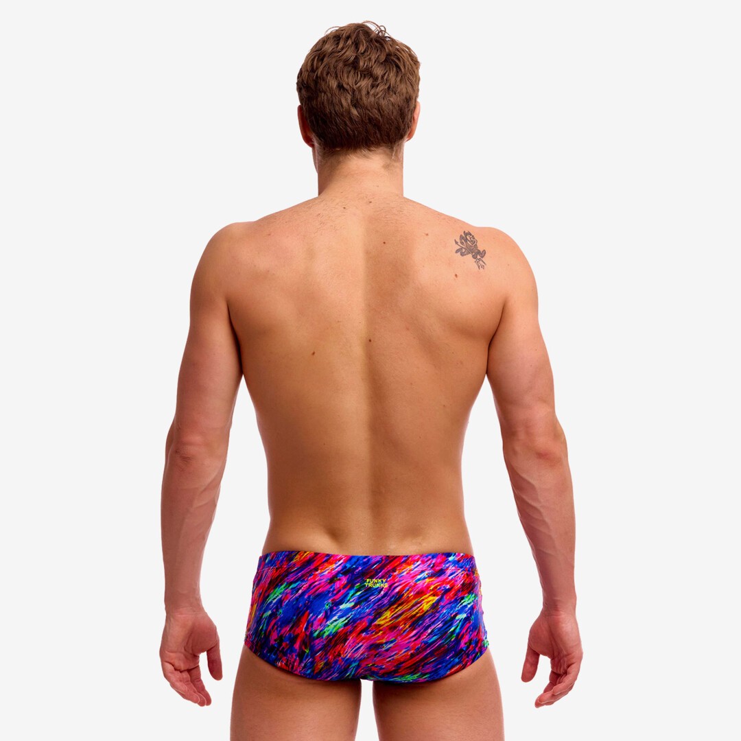 man wearing funky trunks classic trunks in big bang pattern, showing back