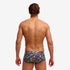 man wearing funky trunks classic trunks in bits of peace pattern, showing back