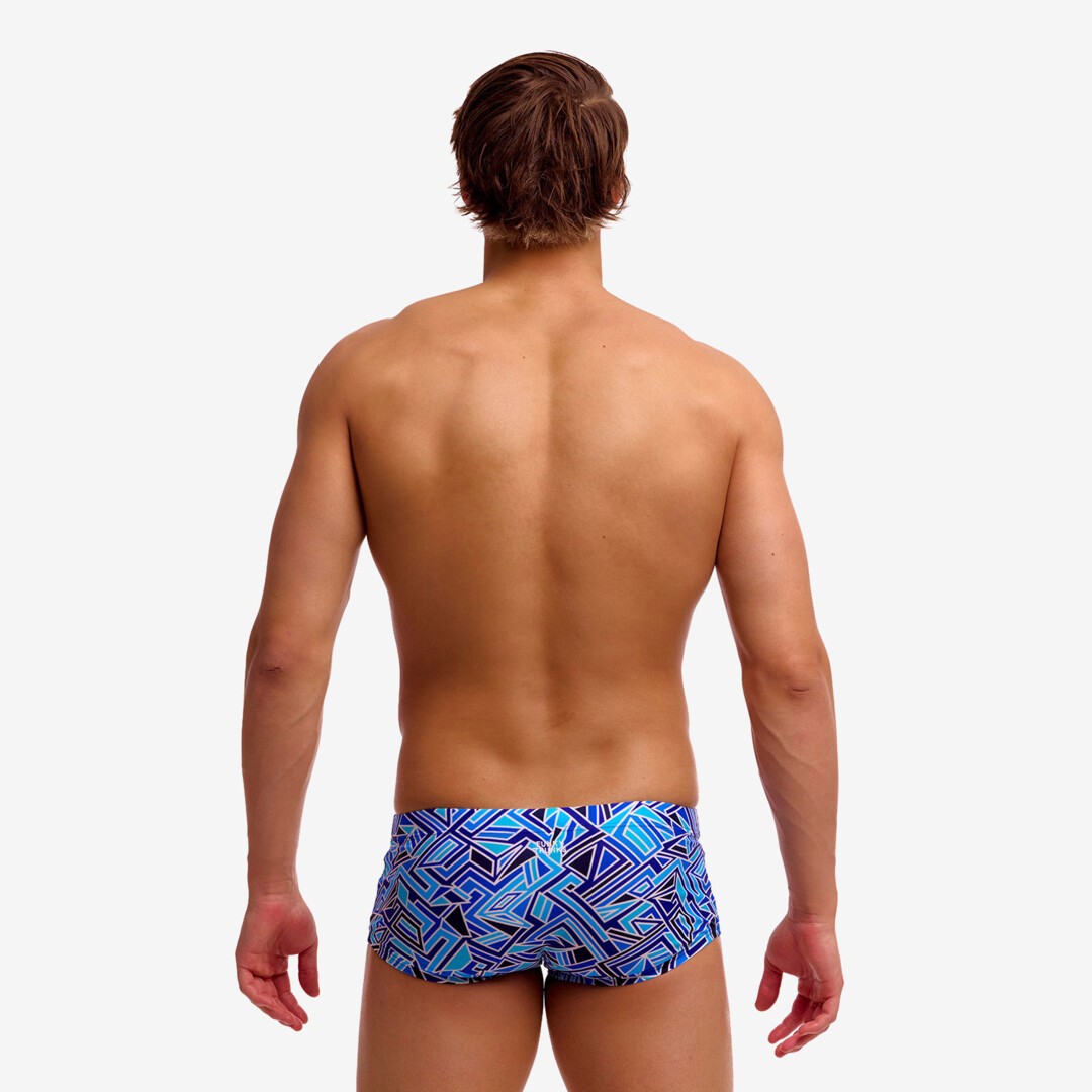 man wearing funky trunks classic trunks in blue bits pattern, showing back