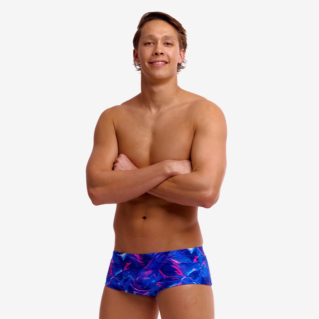 man wearing funky trunks classic trunks in rising tide pattern