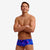 man wearing funky trunks classic trunks in rising tide pattern