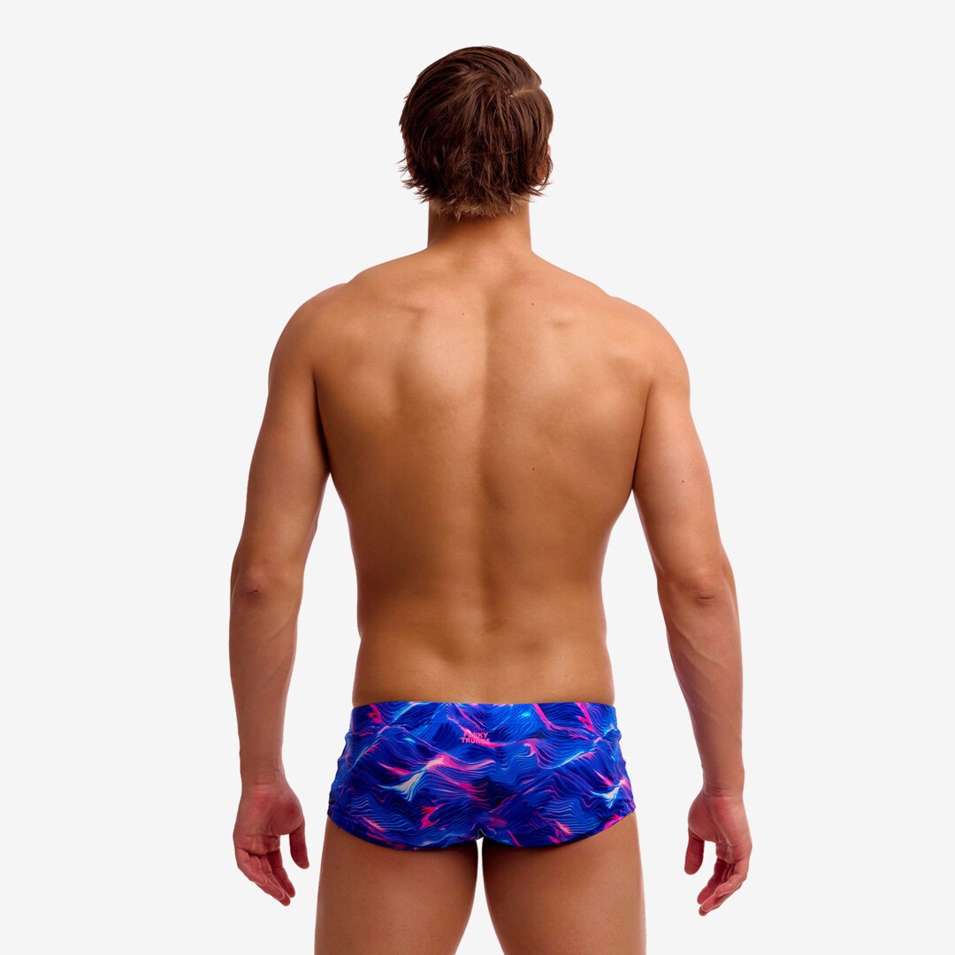 man wearing funky trunks classic trunks in rising tide pattern, showing back